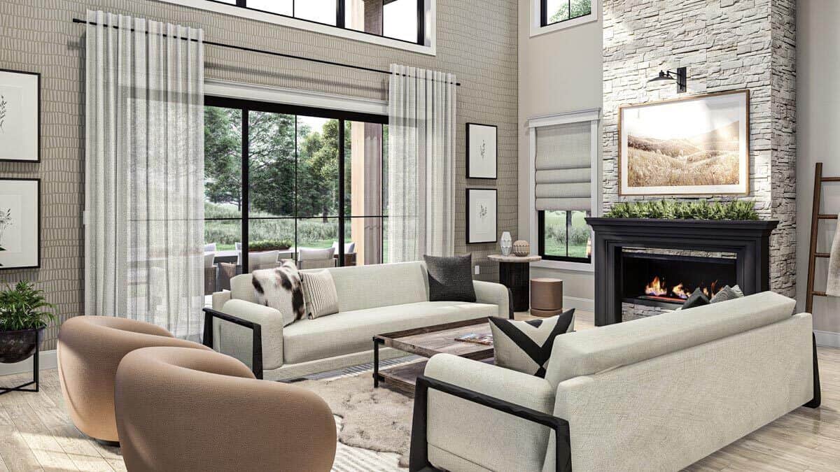 The great room offers contemporary seats, a stone fireplace, and plenty of windows inviting natural light in.