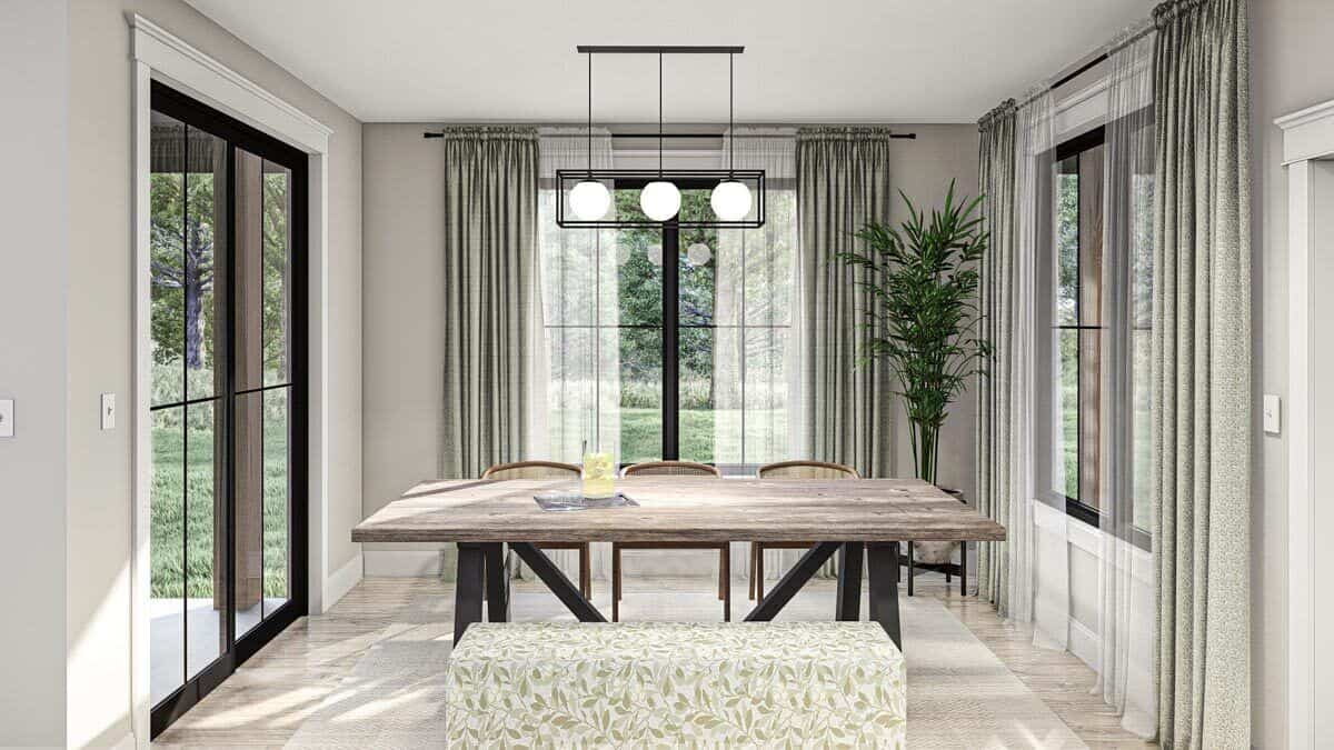 The dining area includes a wooden dining set, a linear chandelier, and direct access to the covered porch through glass sliders.