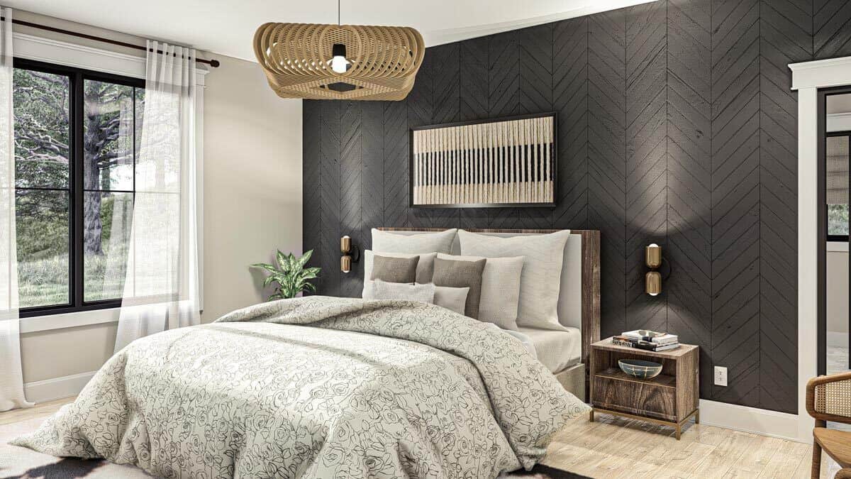 A wood-paneled accent wall arranged in a chevron pattern sets a nice backdrop to the wooden bed.