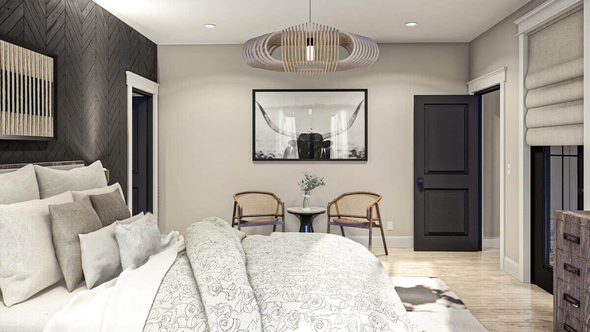 The primary bedroom includes a sitting area adorned with a bull artwork and a modern pendant light.