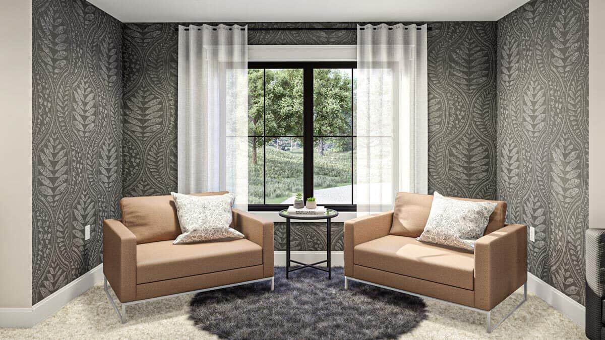 This sitting nook with leather armchairs is graced with dark patterned wallpaper and a round shaggy rug.