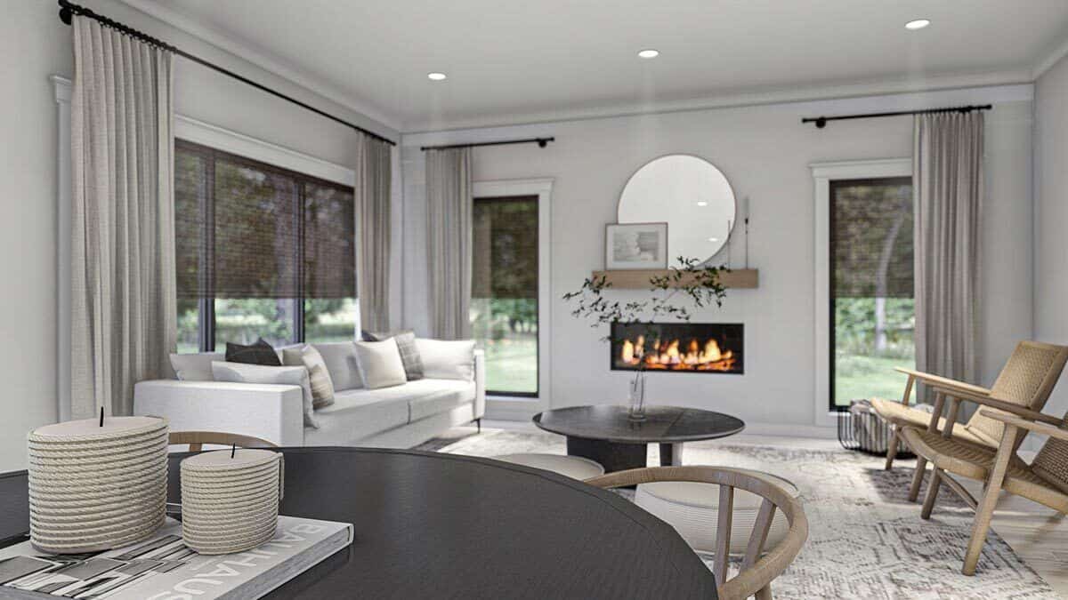Tall windows along with an electric fireplace illuminate the open living space.