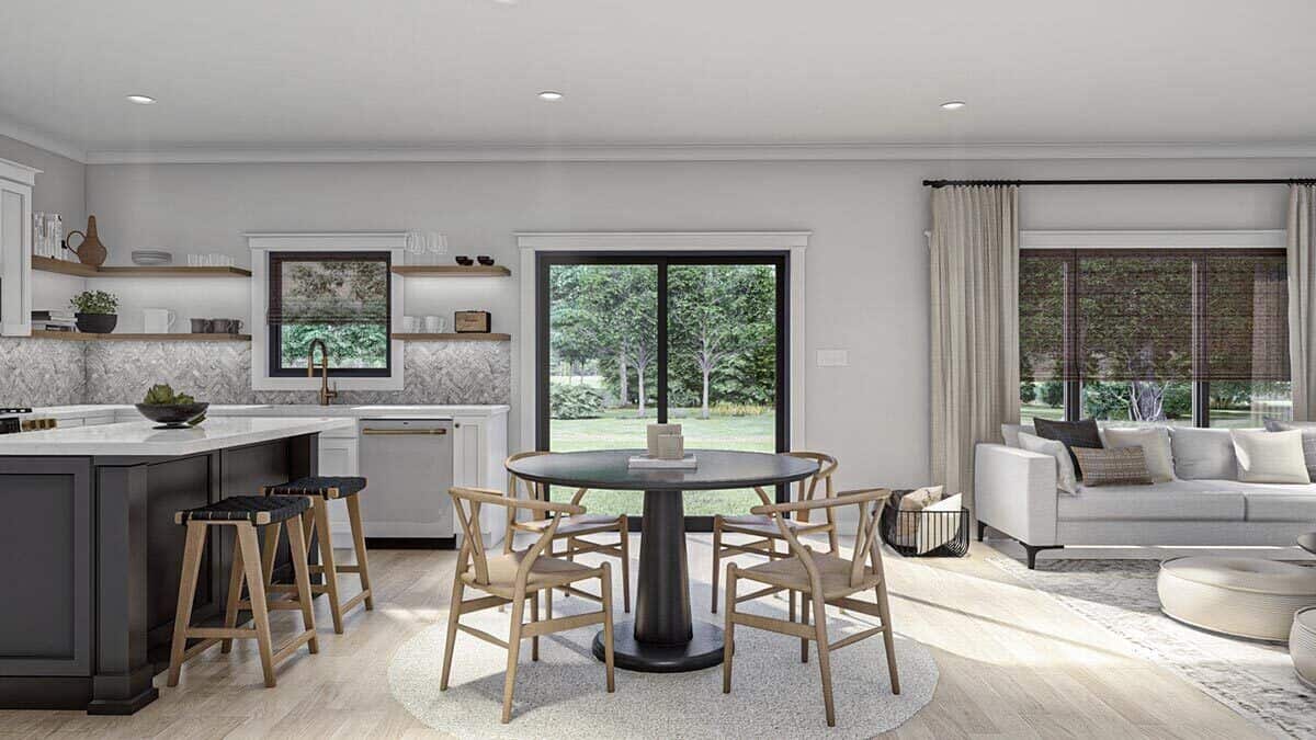 The dining area with a round dining set sits in between the kitchen and living room.