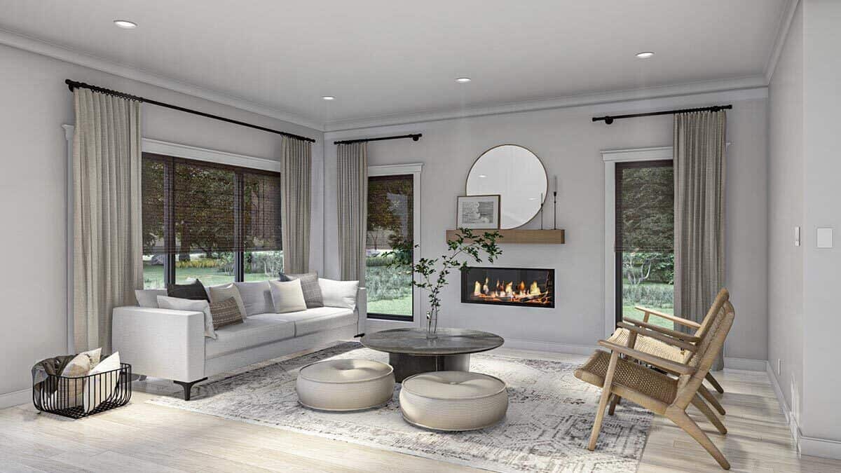 The living room has a gray sofa, wicker armchairs, a round coffee table, and ottomans sitting on a distressed area rug.