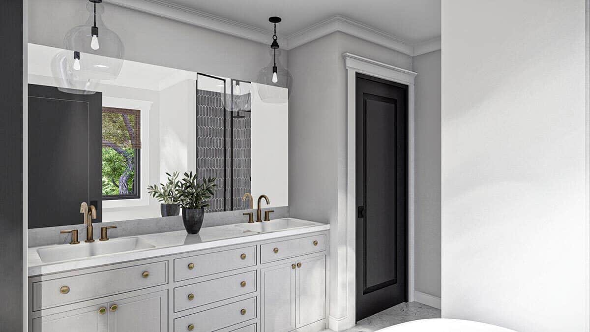 Primary bathroom with a dual sink vanity paired with a rectangular frameless mirror.