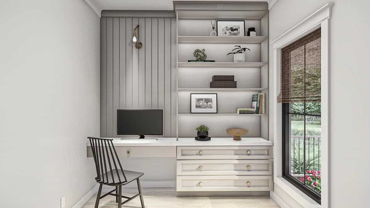 The home office has a built-in desk and a large window that looks out the front porch.