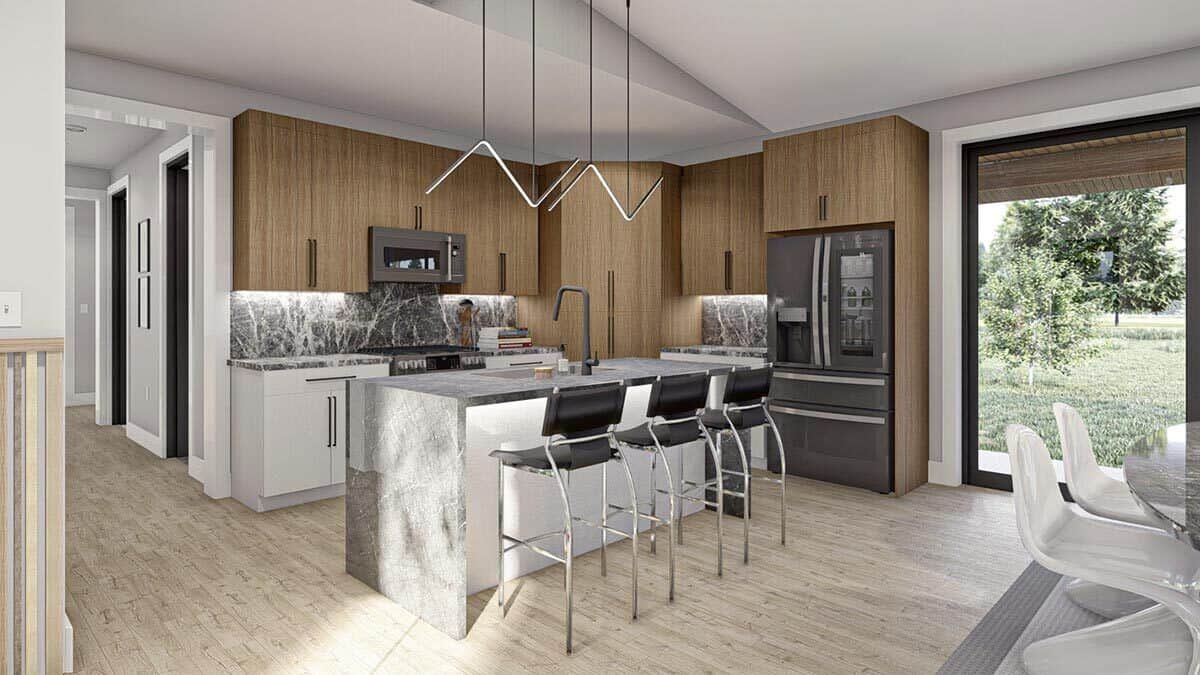 The kitchen has white and wooden cabinets, slate appliances, and a waterfall island lined with three bar stools.