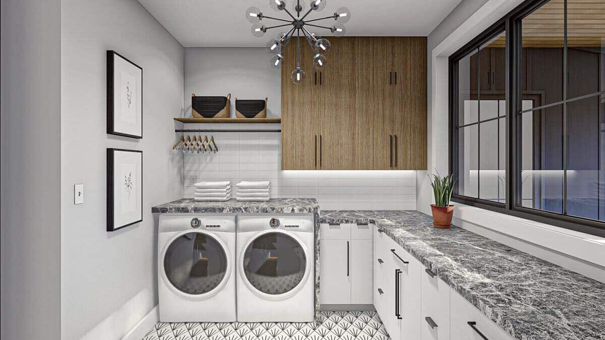 Laundry room with front-load appliances, ample counter space, overhead cabinets, and a floating shelf.