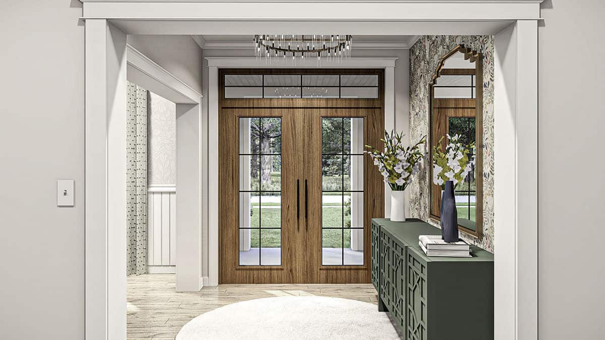 The foyer has a French front door and an intricate console table adorned with a decorative mirror.