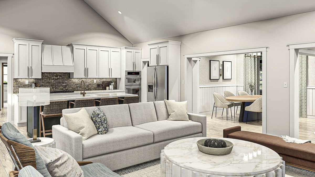 The living room shares the space with the kitchen. They are crowned with a cathedral ceiling and flow seamlessly into the formal dining room.