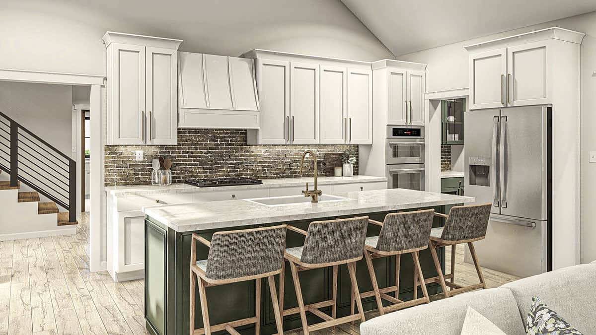 A brick backsplash gives the white kitchen a rich texture.