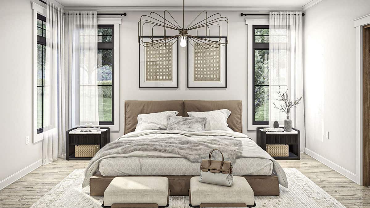 The primary bedroom has dark wood nightstands and a platform bed complemented by a couple of footstools.