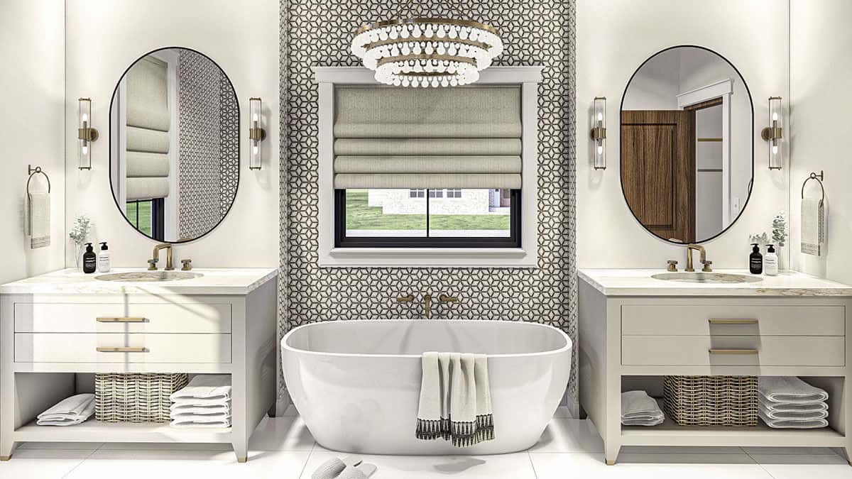 Primary bathroom with his and her sink vanities flanking the freestanding tub.