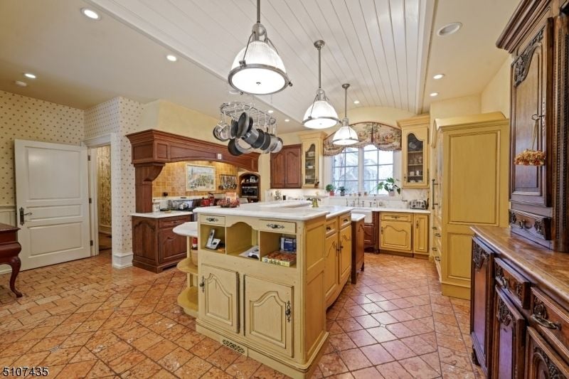 The kitchen features tile flooring and a solid wood cabinet giving off a rustic feel.
