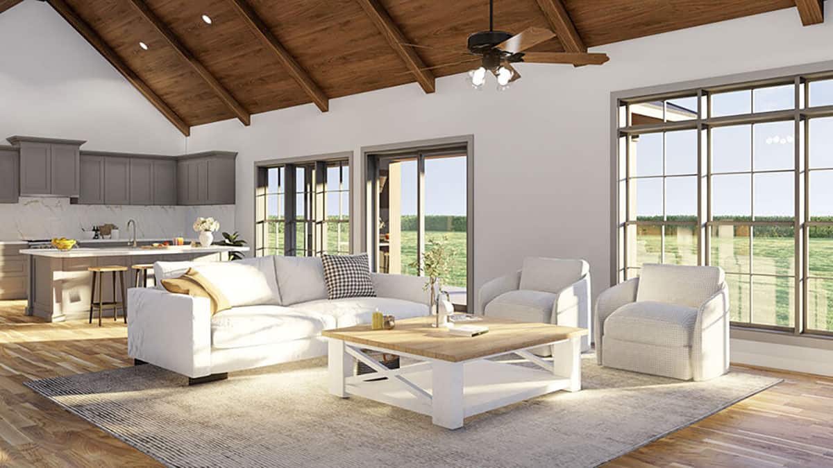 An open layout view of the kitchen and living room defined by a distressed area rug.