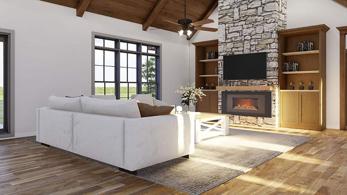 A stone fireplace with a TV on top adds a cozy ambiance to the living room.