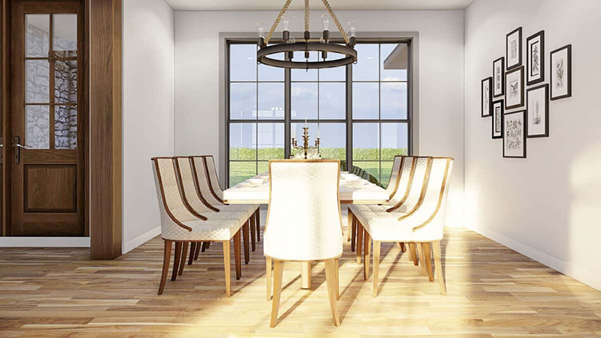 The formal dining room is decorated with a gallery wall and a contemporary dining set topped by a round chandelier.