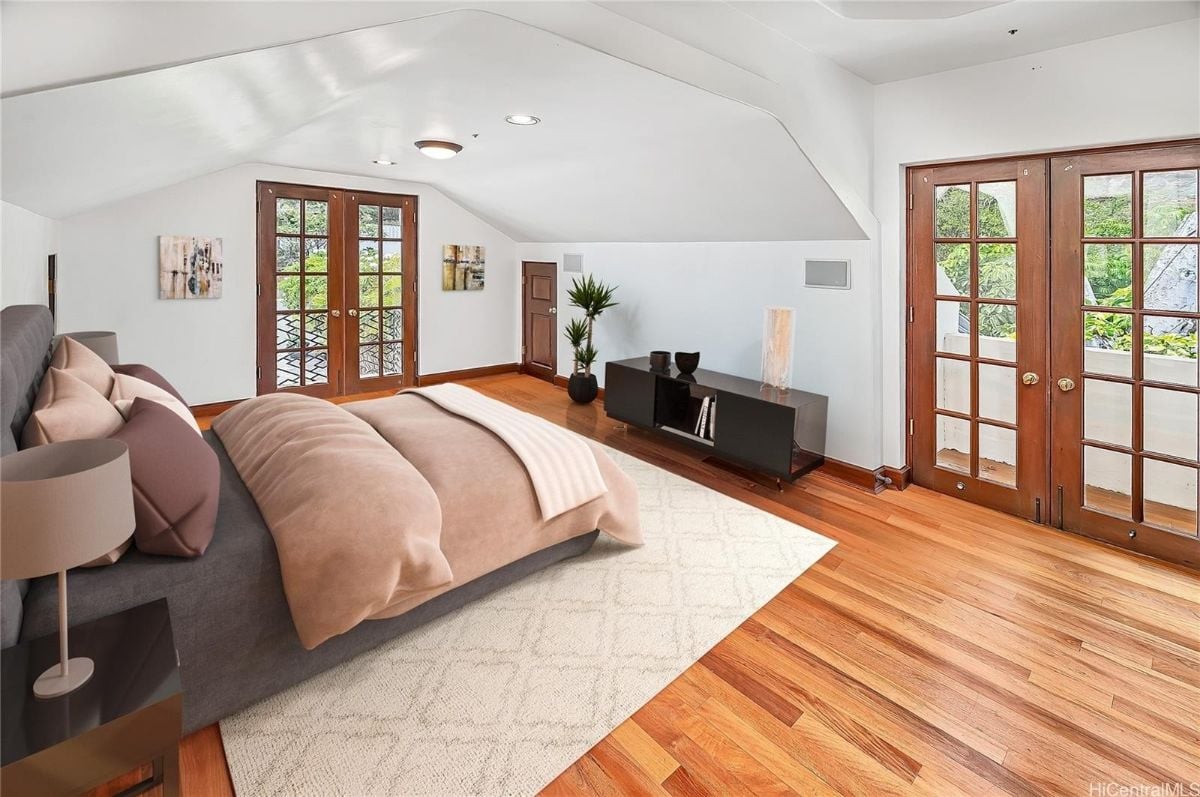 The bedroom features a wooden flooring with wooden doors, giving off a rustic feel to the room.