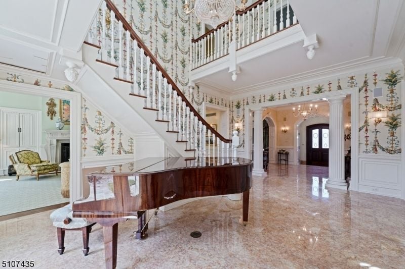 Besides the luxurious staircase is a piano used to entertain guests during events.