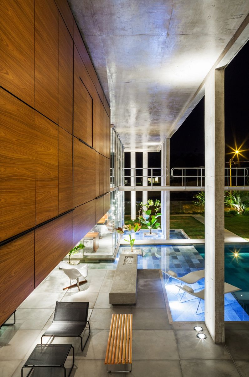 A view of the pool lounge area, landscape, and metallic walkways.