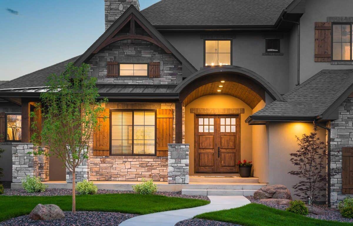 Covered front porch with stone-based columns and a barrel arched entry.