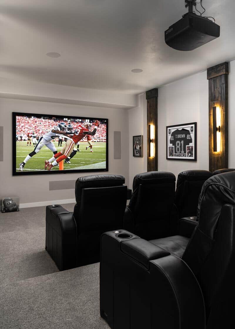The home theater offers leather recliners and a large TV.