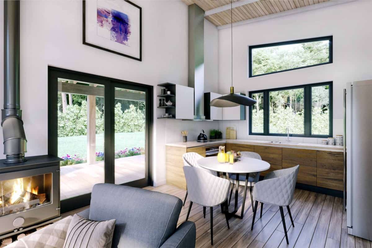 Eat-in kitchen with L-shaped counters, wooden cabinets, and a round dining set topped with a unique pendant light.