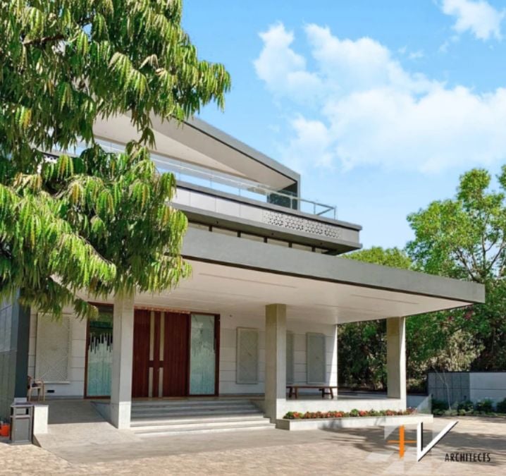 This house features a cantilever roof on the first floor and an open deck on the second floor, creating a unique architectural design.