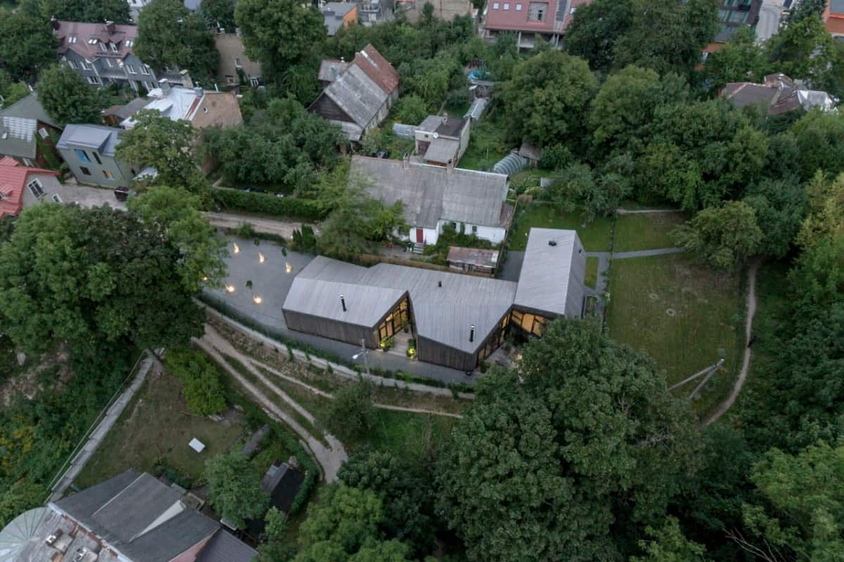 Aerial view of the house showcasing its perimeter surrounded by lush trees.