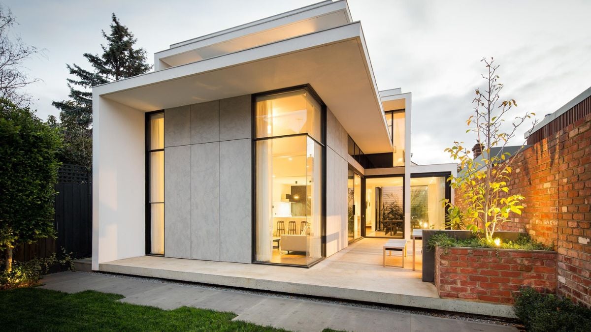 The exterior shot captures a two-way view of the house and its surrounding garden.