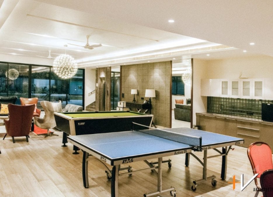 An interior shot of a gaming room filled with a table tennis and billiard table.