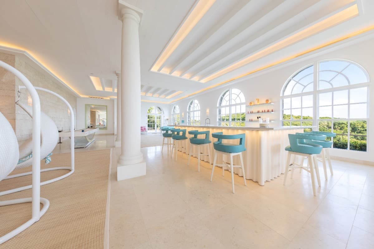 Large arched windows flood this entertaining space with an abundance of natural light.