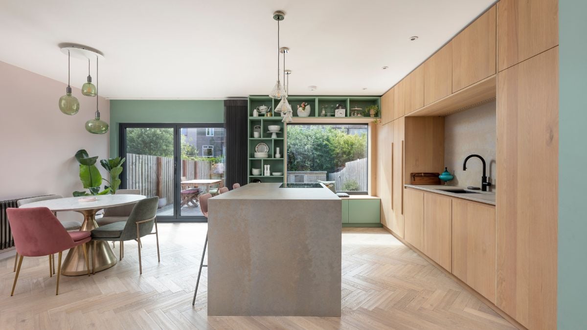 This is a different perspective of an interior photograph showcasing a dining area that is seamlessly integrated with the adjacent kitchen area.