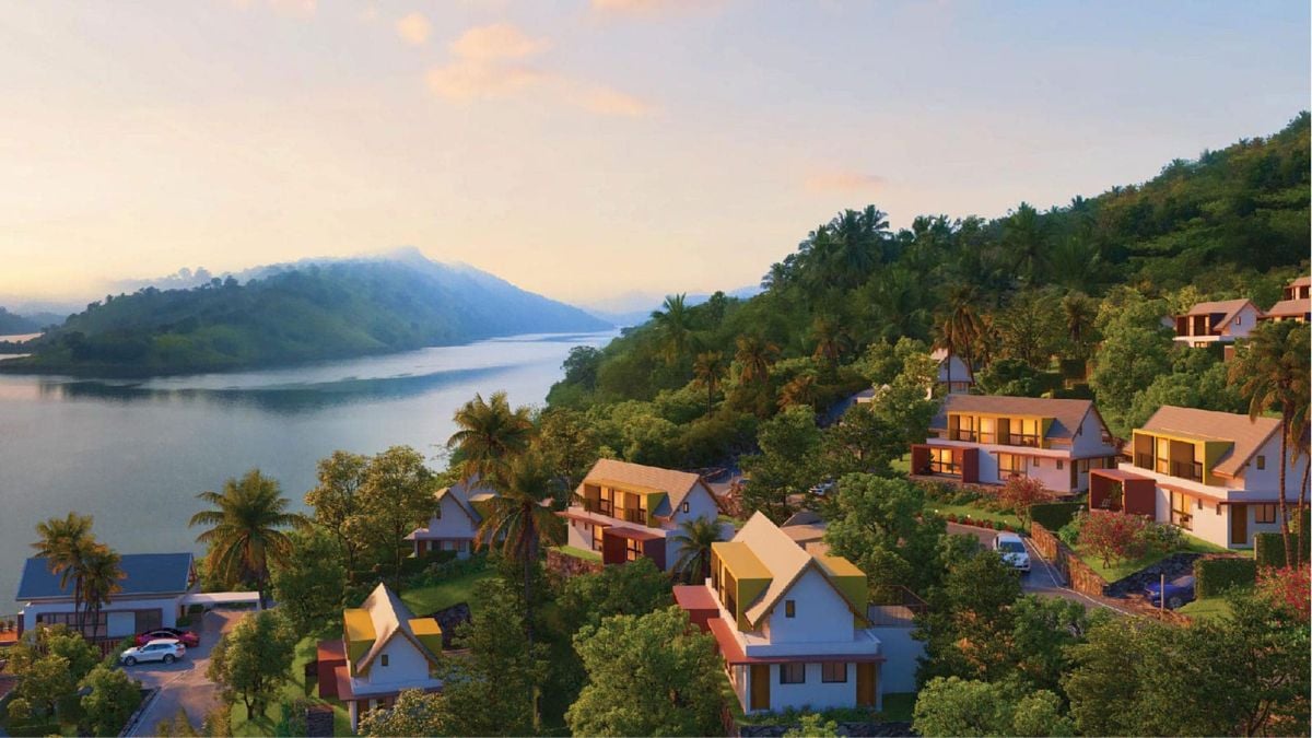 This is a beautiful shot of a residential area located on an island, surrounded by picturesque natural scenery and sparkling water.