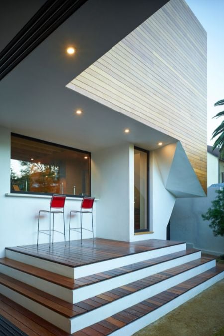 This photograph depicts a set of stairs that lead up to the entrance of a house.