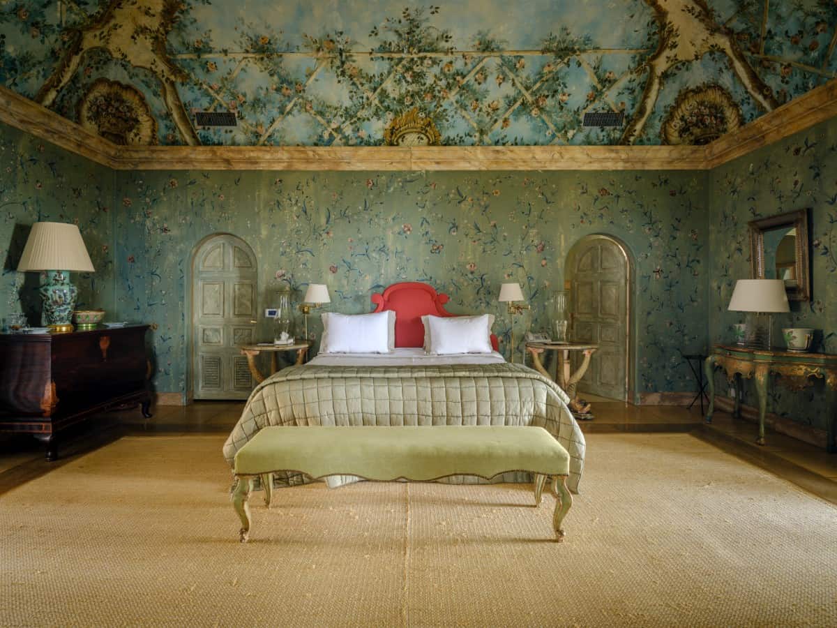 Another hand-painted ceiling mural adorns this bedroom.