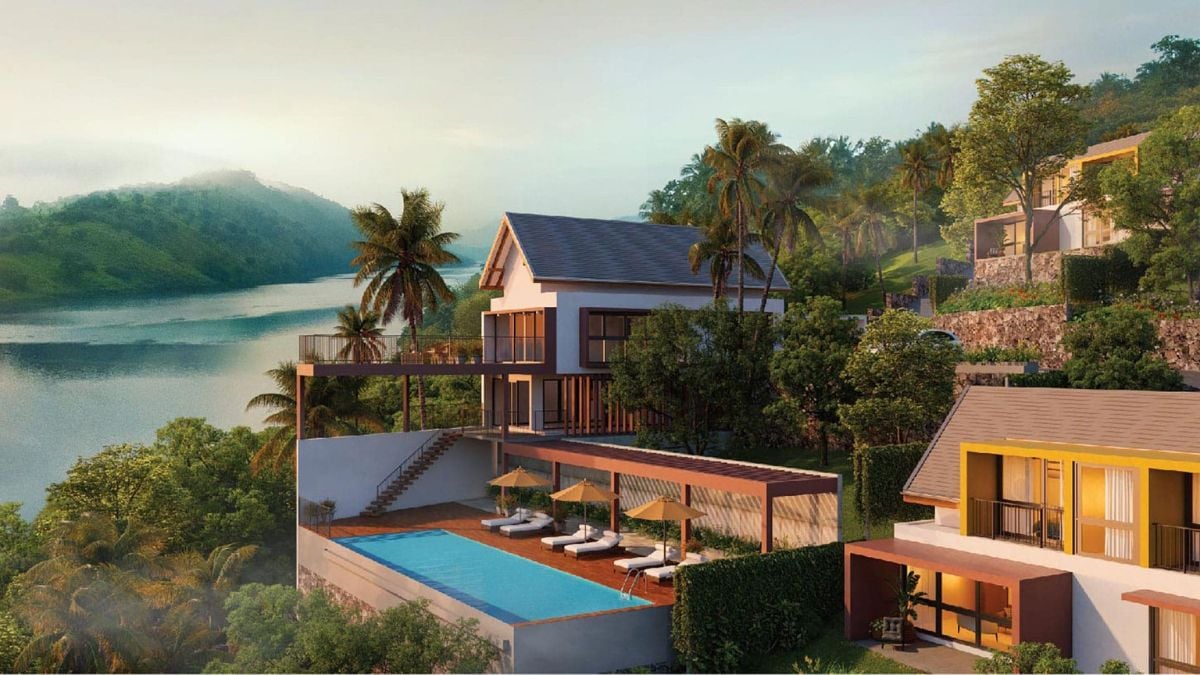 This is a close-up shot of a villa that features an in-ground pool situated below it.
