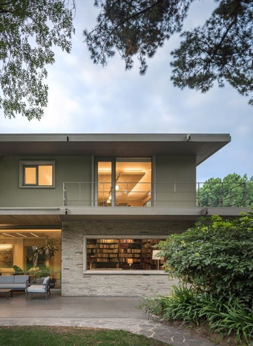 Here is a possible rephrased sentence that sounds more professional:This expansive house boasts numerous windows, providing ample natural light throughout the interior. The lower level features unique wall claddings that set it apart from the second level.