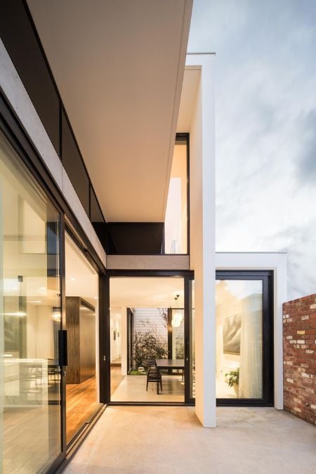 A photograph featuring a specific portion of the house's outdoor area and highlighting the expansive glass doors of the residence.
