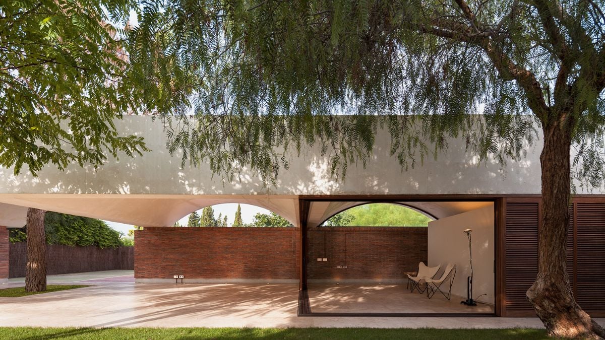 This exterior shot of the rear of the property reveals a vast, open space that can easily accommodate a large number of guests or furnishings, making it an ideal spot for outdoor entertaining and relaxation.