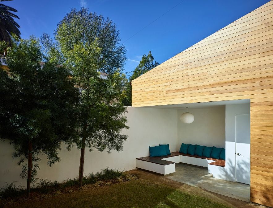 This photograph showcases the exterior of the property, highlighting the outdoor living area that seamlessly blends into the surrounding courtyard.