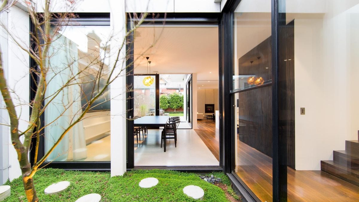 An image offering a glimpse of the dining area and the staircase located on the opposite side.