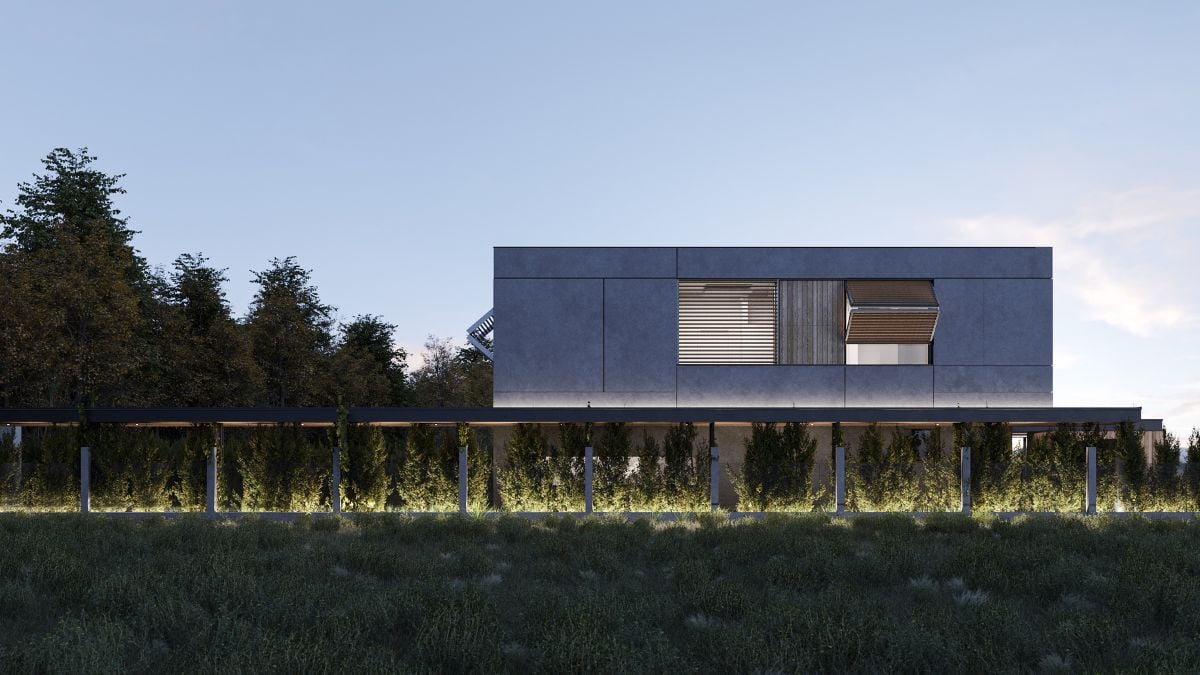 The panoramic shot, taken at dusk, highlights the gray facade of the building, as well as the interior illumination visible through the folding shutters of the windows.