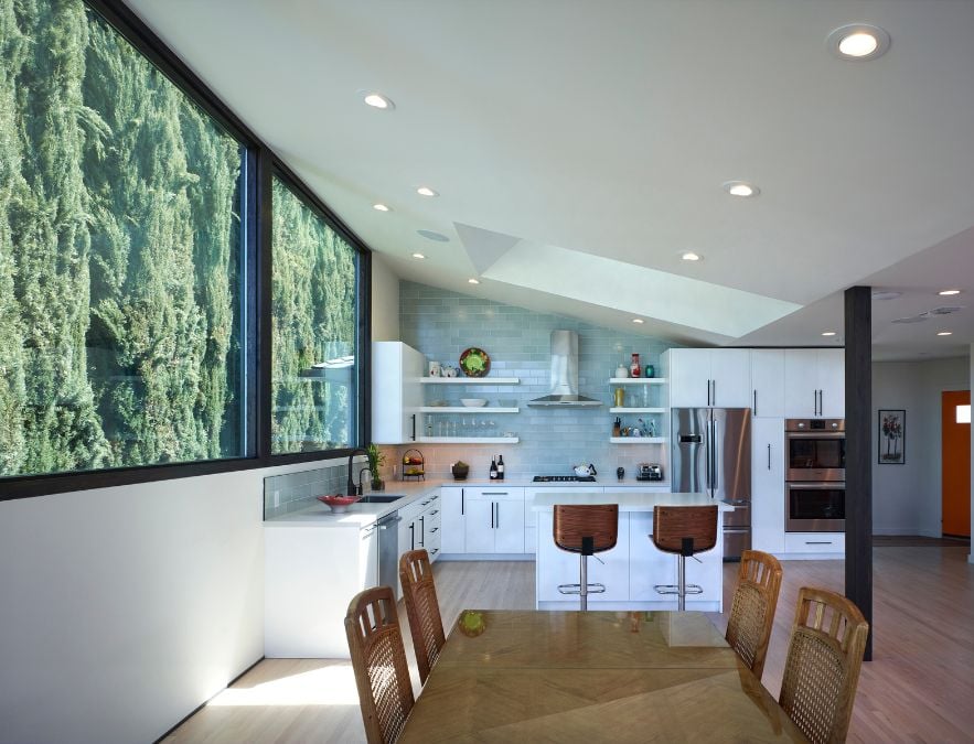 This photograph showcases the dining area within the interior of the residence, which seamlessly blends into the adjoining kitchen space.