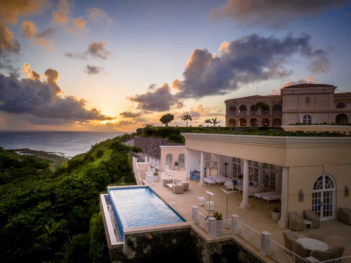 The building also comes with an infinity pool that appears to send water flowing over the lush hillside.