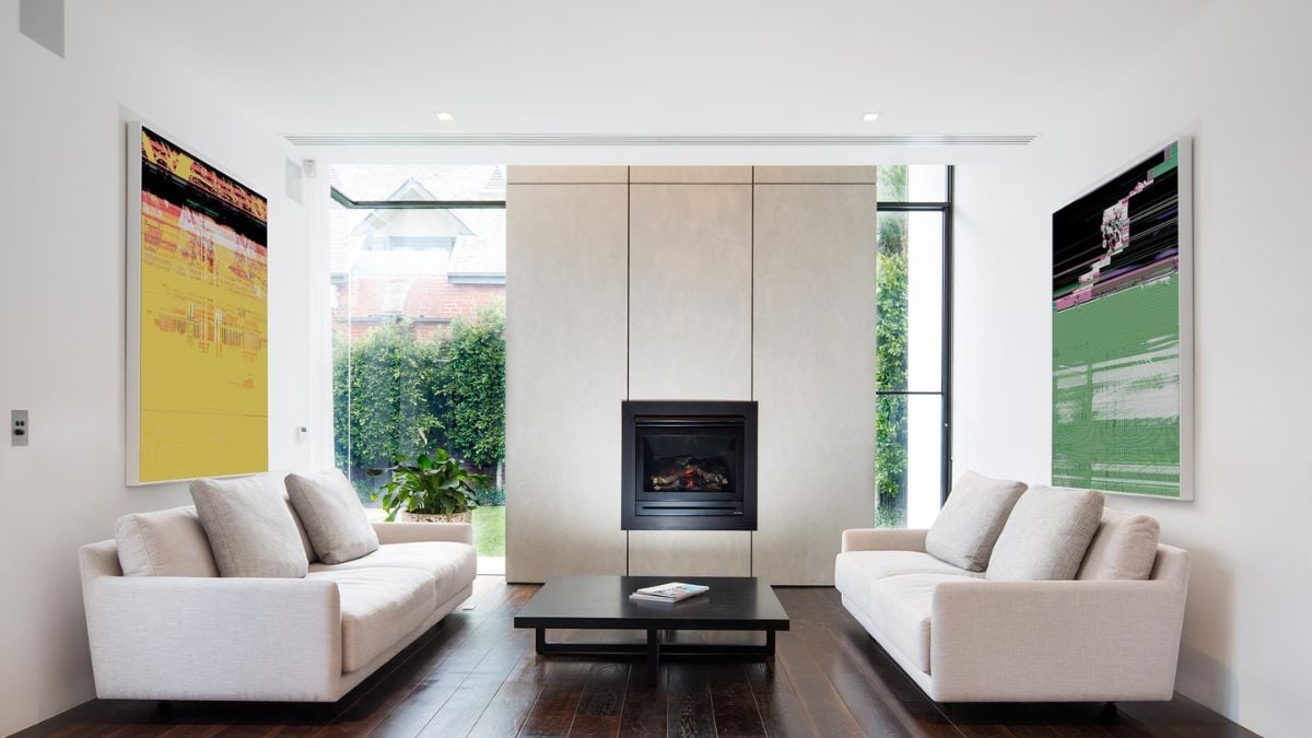 A photograph showcasing a sophisticated living room with two couches and a fireplace.