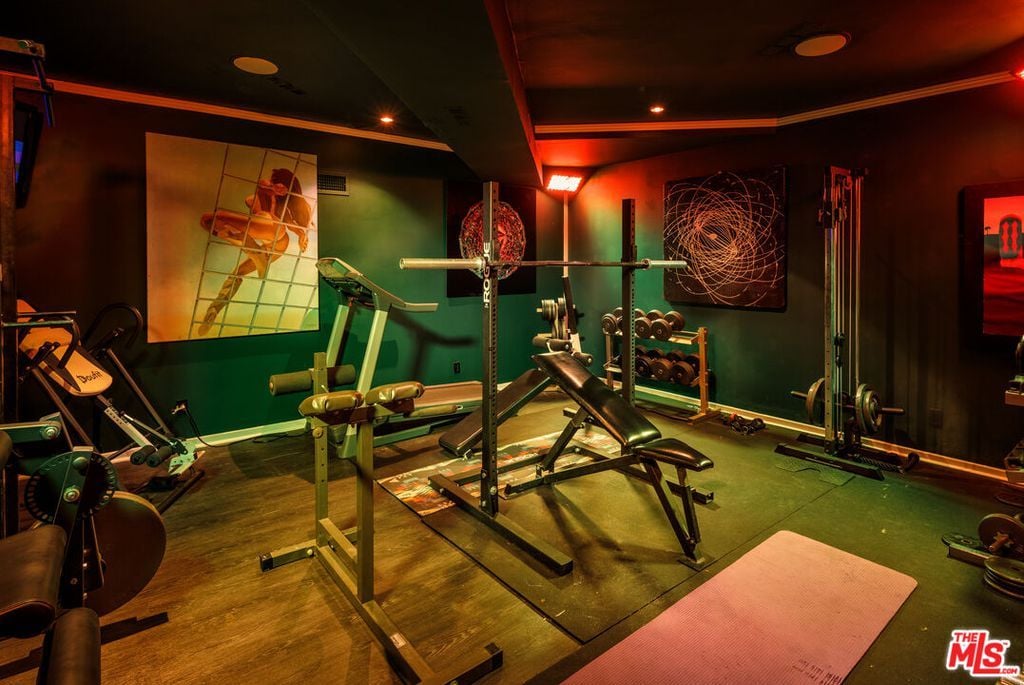 The cozy home gym was the perfect place to escape for a quick workout, with all the necessary equipment readily available.