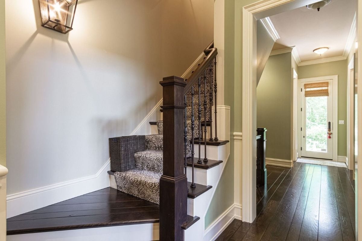 The house features a wooden staircase with stair runners.