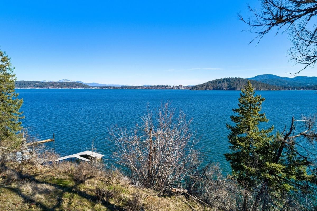 The beautiful lake, the surrounding islands, and the dock for the small boat.