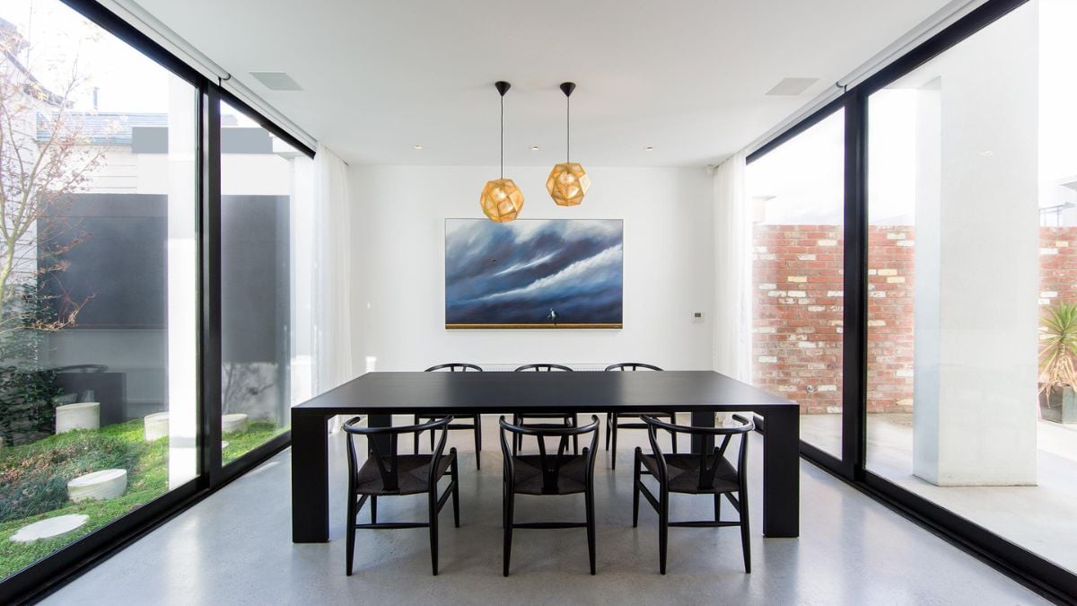 An image that captures the interior design of the dining area that is enclosed by expansive glass wall panels.
